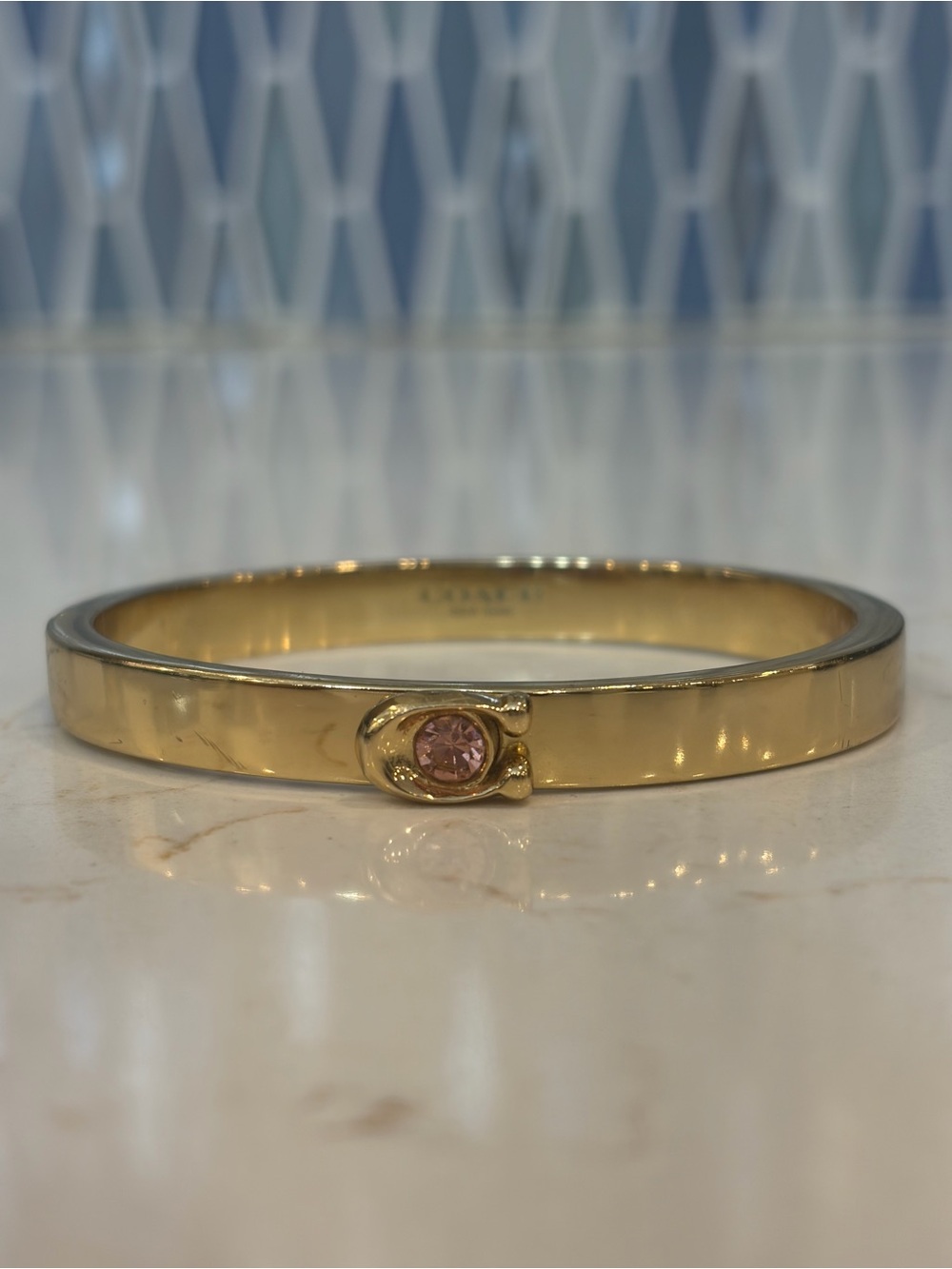 Coach Gold Tone Bangle with Pink Stone